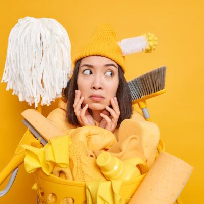 Asian Female Maid Keeps Hands Face Looks Away Uses Different Cleaning Tools Bring House Order Poses Near Laundry Basket Vivid Yellow